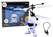 Létající astronaut ovládaný rukou dron helikoptéra bílý